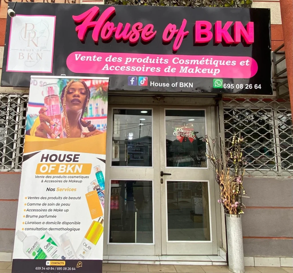 The House of BKN shopfront on Axe Lourd Bonabassem in Douala, with the lit sign above the entrance